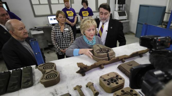 Democratic presidential candidate Hillary Clinton looks at some products as she tours the Cedar Valley TechWorks, Wednesday, Dec. 9, 2015, in Waterloo, Iowa. (AP Photo/Charlie Neibergall)