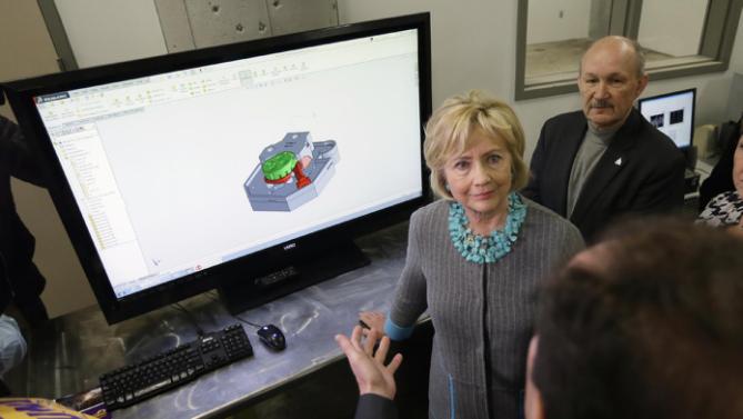 Democratic presidential candidate Hillary Clinton tours the Cedar Valley TechWorks, Wednesday, Dec. 9, 2015, in Waterloo, Iowa. (AP Photo/Charlie Neibergall)