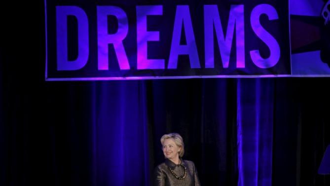 Democratic U.S. presidential candidate Hillary Clinton stands beneath a banner as she is introduced before addressing the 2015 National Immigrant Integration Conference in the Brooklyn borough of New York City, December 14, 2015. REUTERS/Mike Segar