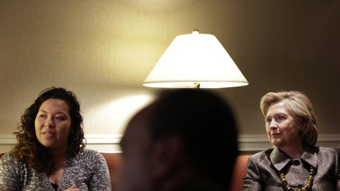 Democratic presidential candidate Hillary Clinton, right,  meets with members of the Suarez family, including Marcy Yonaly Suarez Canales, left, before speaking at the 2015 National Immigration Integration Conference in New York, Monday, Dec. 14, 2015. (AP Photo/Seth Wenig)
