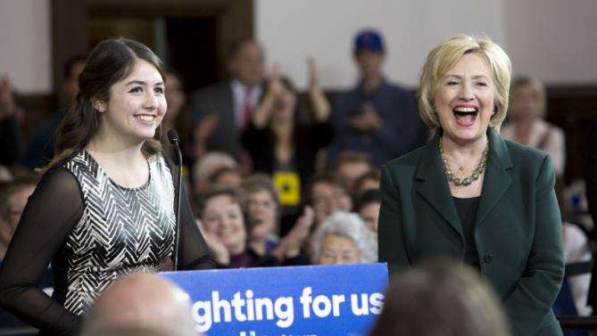 Democratic presidential candidate Hillary Clinton laughs as she is introduced by University of Iowa student Cassidy Schubatt, 19, at a campaign event Wednesday, Dec. 16, 2015, at the Old Brick Church in Iowa City, Iowa. (AP Photo/Scott Morgan)