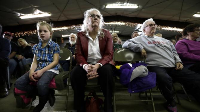 Audience members listen as Democratic presidential candidate Hillary Clinton speaks during a town hall meeting Wednesday, Dec. 16, 2015, in Mason City, Iowa. (AP Photo/Charlie Neibergall)
