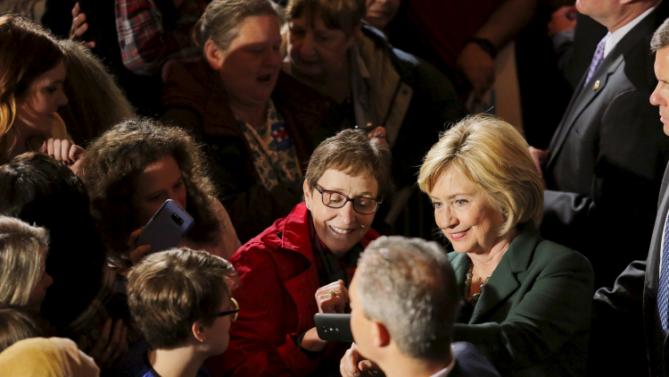 U.S. Democratic presidential candidate Hillary Clinton (R) takes a selfie with a supporter during a campaign rally in Omaha, Nebraska, December 16, 2015.   REUTERS/Lane Hickenbottom