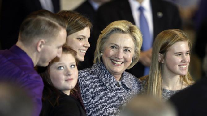 Democratic presidential candidate Hillary Clinton poses for a photo with teacher Schuyler Snakenberg, left, and students Kylea Tinnes, Megan Adam and Abby Schulte, right, during a town hall meeting at Keota High School, Tuesday, Dec. 22, 2015, in Keota, Iowa. (AP Photo/Charlie Neibergall)