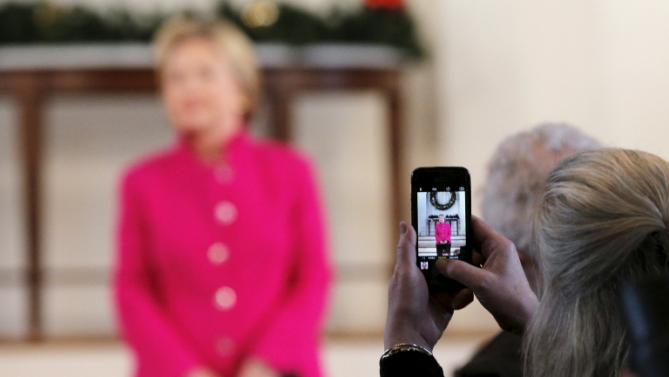 An audience member uses her mobile phone to photograph U.S. Democratic presidential candidate Hillary Clinton at a campaign town hall meeting at South Church in Portsmouth, New Hampshire December 29, 2015.  REUTERS/Brian Snyder