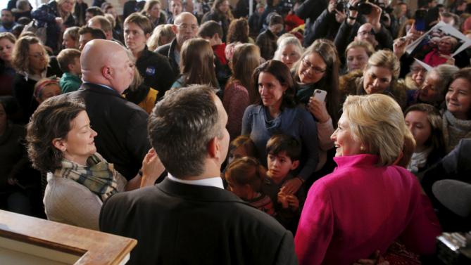 U.S. Democratic presidential candidate Hillary Clinton (R) poses for a photograph with an audience member at a campaign town hall meeting at South Church in Portsmouth, New Hampshire, December 29, 2015.  REUTERS/Brian Snyder