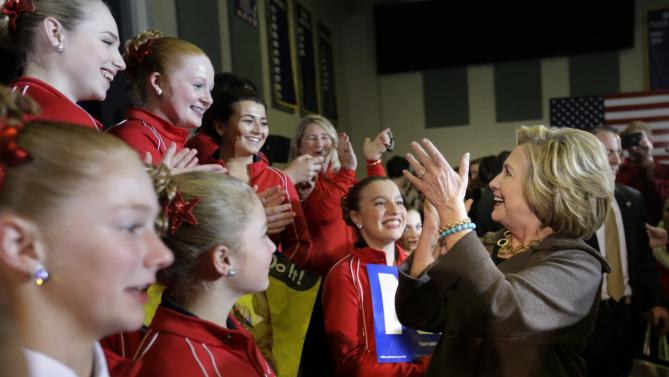 Democratic presidential candidate Hillary Clinton, right, greets members of the International Red Star Twirlers, from Derry, N.H., left, at the conclusion of a town hall style campaign event Sunday, Jan. 3, 2016, in Derry, N.H. (AP Photo/Steven Senne)