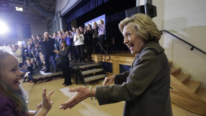Democratic presidential candidate Hillary Clinton, right, greets people in the audience as she arrives at a town hall style campaign event Sunday, Jan. 3, 2016, in Derry, N.H. (AP Photo/Steven Senne)