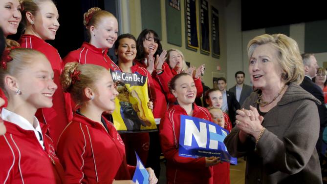 U.S. Democratic presidential candidate Hillary Clinton greets members of the Red Star Twirlers, who performed at her campaign town hall meeting, in Derry, New Hampshire January 3, 2016.  REUTERS/Brian Snyder
