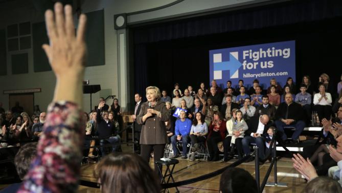 Democratic presidential candidate Hillary Clinton, center, takes questions during a town hall campaign event Sunday, Jan. 3, 2016, in Derry, N.H. (AP Photo/Steven Senne)
