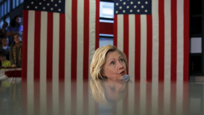 U.S. Democratic presidential candidate Hillary Clinton is reflected in a marble wall as she speaks during a campaign town hall meeting in Concord, New Hampshire January 3, 2016.  REUTERS/Brian Snyder