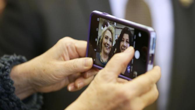 Democratic presidential candidate Hillary Clinton takes a selfie photo with a supporter during a campaign stop at the Osage Public Safety Center, Tuesday, Jan. 5, 2016, in Osage, Iowa. (AP Photo/Charlie Neibergall)