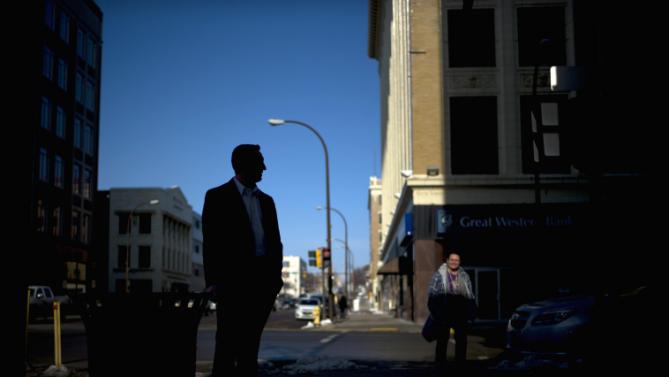 A Secret Service agent stands outside the Orpheum Theatre in Sioux City, Iowa, Tuesday, Jan. 5, 2016, where Democratic presidential candidate Hillary Clinton is scheduled to host a rally. (AP Photo/Jae C. Hong)