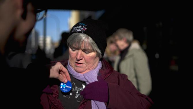 Iona Michaelis of West Point, Neb., gets a campaign sticker outside the Orpheum Theatre in Sioux City, Iowa, Tuesday, Jan. 5, 2016, where Democratic presidential candidate Hillary Clinton is scheduled to host a rally. (AP Photo/Jae C. Hong)