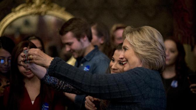 Democratic presidential candidate Hillary Clinton takes a selfie with a supporter after speaking at a rally at the Orpheum Theatre, Tuesday, Jan. 5, 2016, in Sioux City, Iowa. (AP Photo/Jae C. Hong)