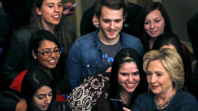 U.S. Democratic presidential candidate Hillary Clinton takes a "selfie" photograph with supporters at a campaign event in Sioux City, Iowa, United States, January 5, 2016. REUTERS/Jim Young