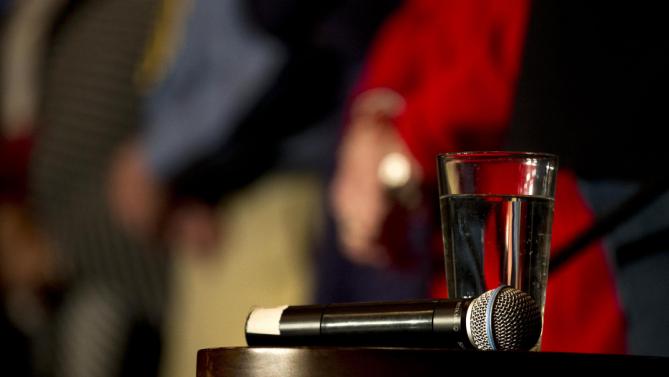 A microphone and a glass of water are placed on a stool for Democratic presidential candidate Hillary Clinton at a rally, Tuesday, Jan. 5, 2016, in Sioux City, Iowa. (AP Photo/Jae C. Hong)