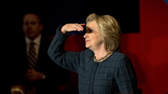 Democratic presidential candidate Hillary Clinton shields her eyes from the light while listening to a question during a rally held at the Orpheum Theatre, Tuesday, Jan. 5, 2016, in Sioux City, Iowa. (AP Photo/Jae C. Hong)