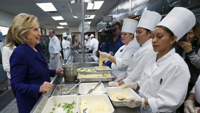 U.S. Democratic presidential candidate Hillary Clinton talks to students making lasagna while touring the Culinary Academy of Las Vegas in North Las Vegas, Nevada January 6, 2016. REUTERS/Rick Wilking