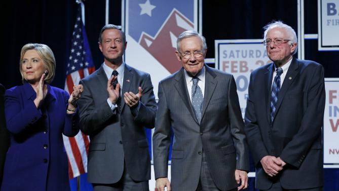 Democratic presidential candidates Hillary Clinton, left, Martin O'Malley, second from left, and Sen. Bernie Sanders, I-Vt., right, stand on stage with Senate Minority Leader Harry Reid, D-Nev., during the Battle Born Battleground First in the West Caucus Dinner, Wednesday, Jan. 6, 2016, in Las Vegas. (AP Photo/John Locher)