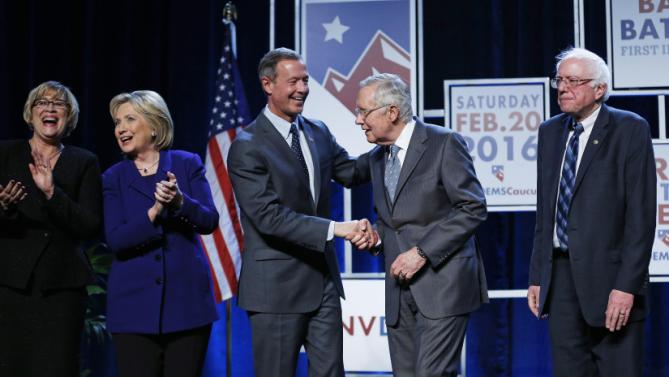 From left, Roberta Lange, chairwoman of the Nevada State Democratic Party, Democratic presidential candidate Hillary Clinton, Democratic presidential candidate, former Maryland Gov. Martin O'Malley, Senate Minority Leader Harry Reid, D-Nev., and Democratic presidential candidate Sen. Bernie Sanders, I-Vt., stand on stage during the Battle Born Battleground First in the West Caucus Dinner, Wednesday, Jan. 6, 2016, in Las Vegas. (AP Photo/John Locher)