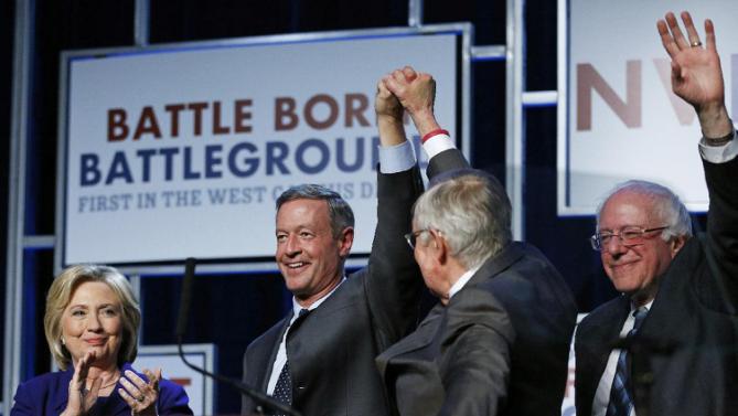 Democratic presidential candidates Hillary Clinton, left, Martin O'Malley, second from left, and Sen. Bernie Sanders, I-Vt., right, stand on stage with Senate Minority Leader Harry Reid, D-Nev., during the Battle Born Battleground First in the West Caucus Dinner, Wednesday, Jan. 6, 2016, in Las Vegas. (AP Photo/John Locher)