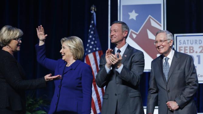 Democratic presidential candidates Hillary Clinton, second from left, and Martin O'Malley, second from right, stand on stage with Senate Minority Leader Harry Reid, D-Nev., right and Roberta Lange, chairwoman of the Nevada State Democratic Party, during the Battle Born Battleground First in the West Caucus Dinner, Wednesday, Jan. 6, 2016, in Las Vegas. (AP Photo/John Locher)