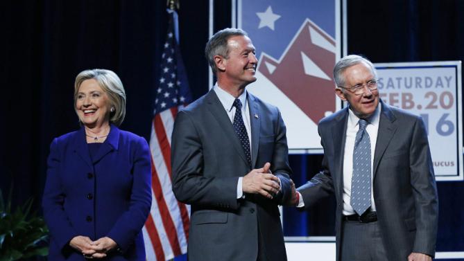 Democratic presidential candidates Hillary Clinton, left, and Martin O'Malley, second from left, stand on stage with Senate Minority Leader Harry Reid, D-Nev., during the Battle Born Battleground First in the West Caucus Dinner, Wednesday, Jan. 6, 2016, in Las Vegas. (AP Photo/John Locher)