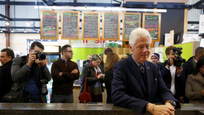 Former U.S. President Bill Clinton greets customers and employees while campaigning for his wife, Democratic presidential candidate Hillary Clinton, at the NewBo Market in Cedar Rapids, Iowa, January 7, 2016. REUTERS/Aaron P. Bernstein