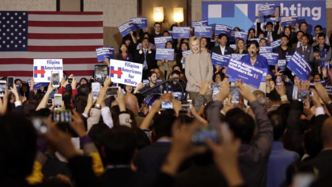 Democratic presidential  candidate Hillary Clinton, middle, is welcomed by Rep. Judy Chu, D-Calif., at podium, before addressing Asian American and Pacific Islander supporters in San Gabriel, Calif., on Thursday, Jan. 7, 2016. (AP Photo/Damian Dovarganes)