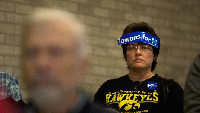 With a campaign sticker on her forehead, Robin Heath listens as Democratic presidential candidate Hillary Clinton speaks at a rally, Monday, Jan. 11, 2016, in Waterloo, Iowa. (AP Photo/Jae C. Hong)