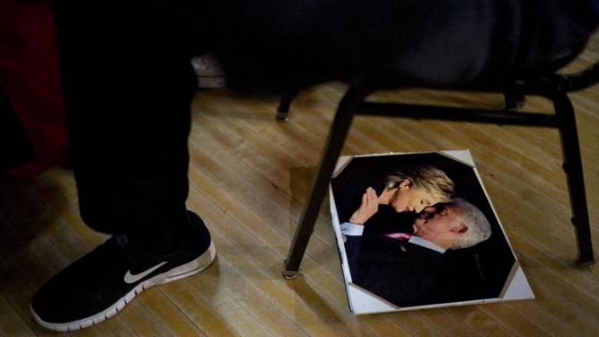 A photo of former President Bill Clinton and Democratic presidential candidate Hillary Clinton kissing is seen on the floor during a campaign rally with the candidate, Monday, Jan. 11, 2016, in Waterloo, Iowa. (AP Photo/Jae C. Hong)