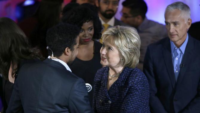 Democratic presidential candidate, Hillary Clinton talks to the moderators after the Brown & Black Forum, Monday, Jan. 11, 2016, in Des Moines, Iowa. (AP Photo/Charlie Neibergall)