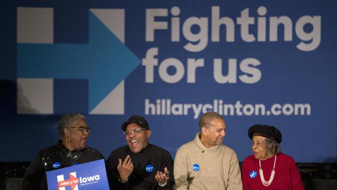 Supporters share a laugh and chat while waiting for Democratic presidential candidate Hillary Clinton at a campaign rally, Monday, Jan. 11, 2016, in Waterloo, Iowa. (AP Photo/Jae C. Hong)