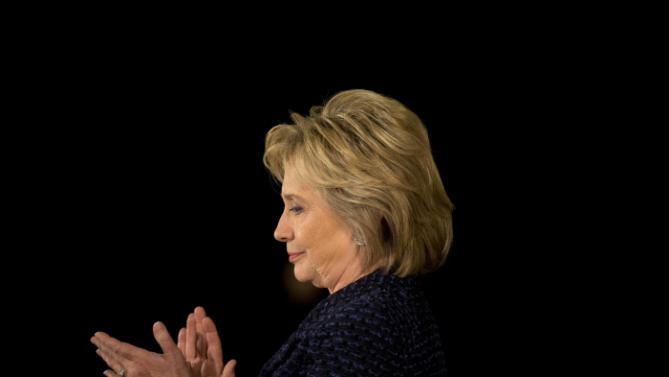 Democratic presidential candidate Hillary Clinton applauds while listening to Transportation Secretary Anthony Foxx speaks during a campaign rally, Monday, Jan. 11, 2016, in Waterloo, Iowa. (AP Photo/Jae C. Hong)