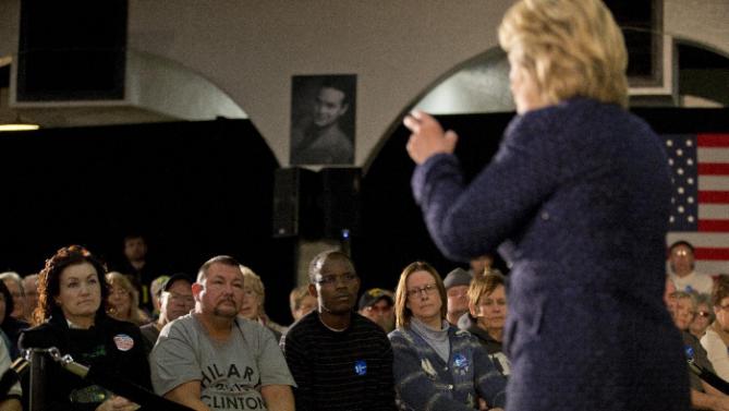 People listens to Democratic presidential candidate Hillary Clinton at a rally Monday, Jan. 11, 2016, in Waterloo, Iowa. (AP Photo/Jae C. Hong)