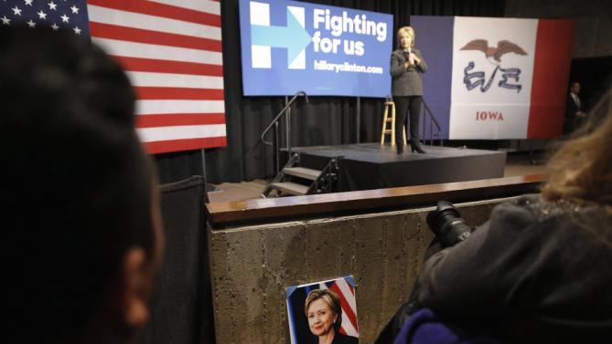 A photograph of Democratic presidential candidate Hillary Clinton sits in front of an attendee as Clinton speaks during a campaign event at Iowa State University in Ames, Iowa, Tuesday, Jan. 12, 2016. (AP Photo/Patrick Semansky)