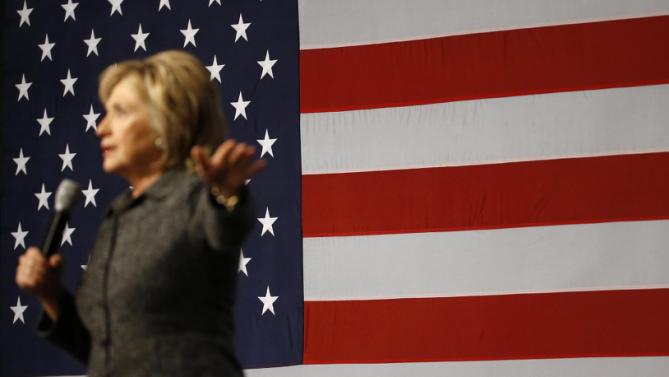 An American flag stands behind Democratic presidential candidate Hillary Clinton as she speaks during a campaign event at Iowa State University in Ames, Iowa, Tuesday, Jan. 12, 2016. (AP Photo/Patrick Semansky)
