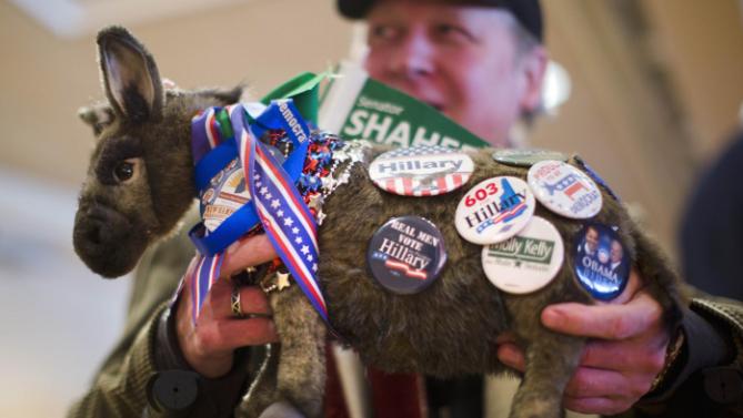 Keith Halloran holds his stuffed donkey with political pins  before former President Bill Clinton spoke at a campaign stop for his wife, Democratic presidential candidate Hilary Clinton, Wednesday, Jan. 13, 2016, at Keene State College in Keene, N.H. (AP Photo/Matt Rourke)