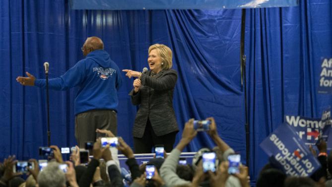 Democratic presidential candidate Hillary Clinton points to a supporter after she is introduced by Rep. Jim Clyburn (D-SC), left. before she speak to a crowd at the Jim Clyburn Fish Fry, on Saturday, Jan. 16, 2016, at the Charleston Visitor Center in Charleston, S.C. (AP Photo/Stephen B. Morton)