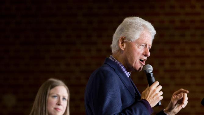 Former President Bill Clinton, accompanied by his daughter Chelsea Clinton, left, speaks at a campaign stop for his wife Democratic presidential candidate Hillary Clinton at Lincoln High School in Des Moines, Iowa, Saturday, Jan. 16, 2016(AP Photo/Andrew Harnik)