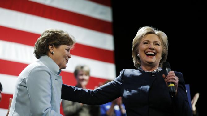 Democratic presidential candidate Hillary Clinton, right, takes the microphone after being introduced by Sen. Jeanne Shaheen, D-N.H., during a campaign stop Friday, Jan. 22, 2016, in Rochester, N.H. (AP Photo/Matt Rourke)