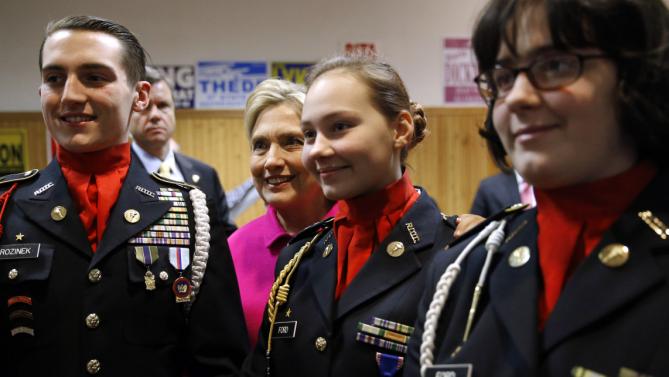 Democratic presidential candidate Hillary Clinton poses for a photograph with members of a color guard after speaking at the Scott County Democrats Red, White and Blue Banquet in Davenport, Iowa, Saturday, Jan. 23, 2016. (AP Photo/Patrick Semansky)