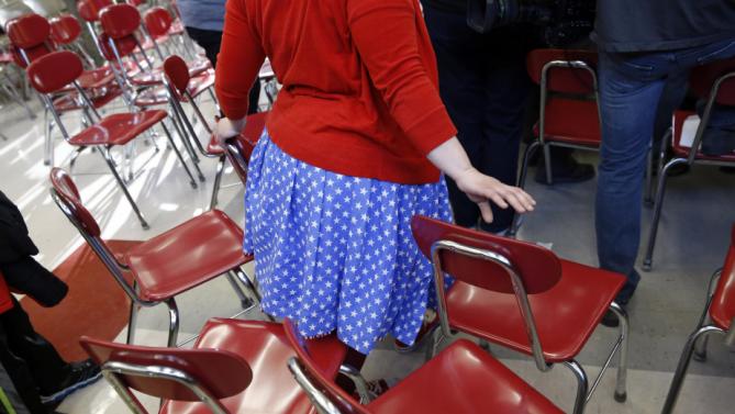 A woman wearing patriotic colors makes her way through chairs to get a closer view of Democratic presidential candidate Hillary Clinton after a town hall at Eagle Heights Elementary School in Clinton, Iowa, Saturday, Jan. 23, 2016. (AP Photo/Patrick Semansky)