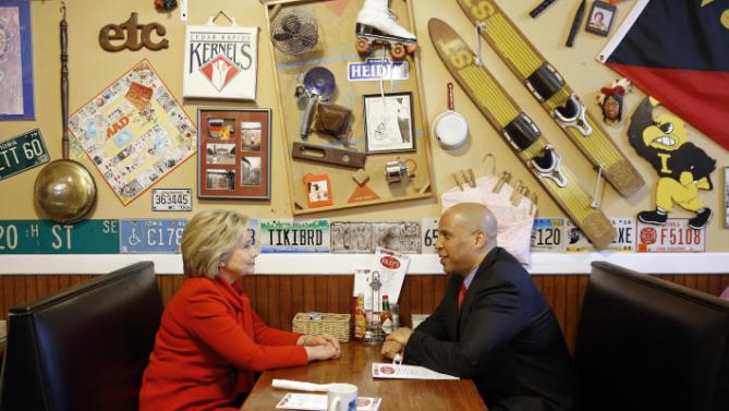 Democratic presidential candidate Hillary Clinton, left, chats with Sen. Cory Booker, D-N.J., at Riley's Cafe in Cedar Rapids, Iowa, Sunday, Jan. 24, 2016. (AP Photo/Patrick Semansky)
