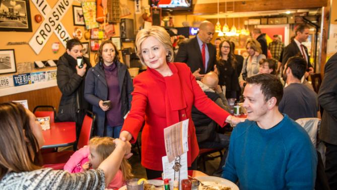 CEDAR RAPIDS, IOWA - JANUARY 24: Democratic presidential candidate Hillary Clinton (C) greets diners at Riley's Cafe on January 24, 2016 in Cedar Rapids, Iowa. The Democratic and Republican Iowa Caucuses, the first step in nominating a presidential candidate from each party, will take place on February 1. (Photo by Brendan Hoffman/Getty Images)