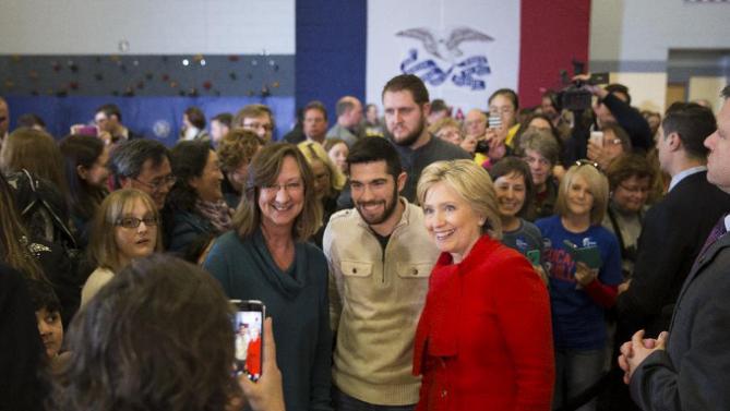 Democratic presidential candidate Hillary Clinton takes photos with supporters during a campaign rally at Burford Garner Elementary School, on Sunday, Jan. 24, 2016, in North Liberty, Iowa. (AP Photo/Evan Vucci)