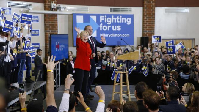 Democratic presidential candidate Hillary Clinton waves to supporters alongside Chad Griffin, president of the Human Rights Campaign, at Valley Southwoods Freshman High School in West Des Moines, Iowa, Sunday, Jan. 24, 2016. (AP Photo/Patrick Semansky)