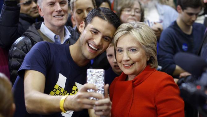 Democratic presidential candidate Hillary Clinton poses for a selfie with a supporter after speaking at Valley Southwoods Freshman High School in West Des Moines, Iowa, Sunday, Jan. 24, 2016. (AP Photo/Patrick Semansky)