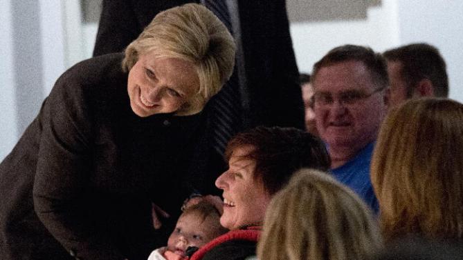 Democratic presidential candidate Hillary Clinton poses for a photo with an infant during a campaign event at the Jewish Federation of Greater Des Moines, Monday, Jan. 25, 2016, in Des Moines, Iowa. (AP Photo/Mary Altaffer)
